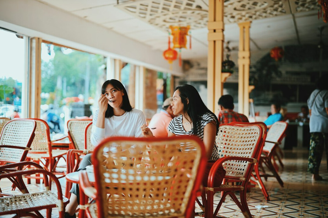 Friends talking and listening to each other at a table